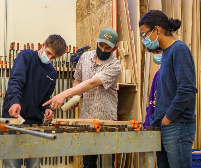 Michael Black (center) is finally getting to teach shop in person after months online. Photo by Sue Rollyson